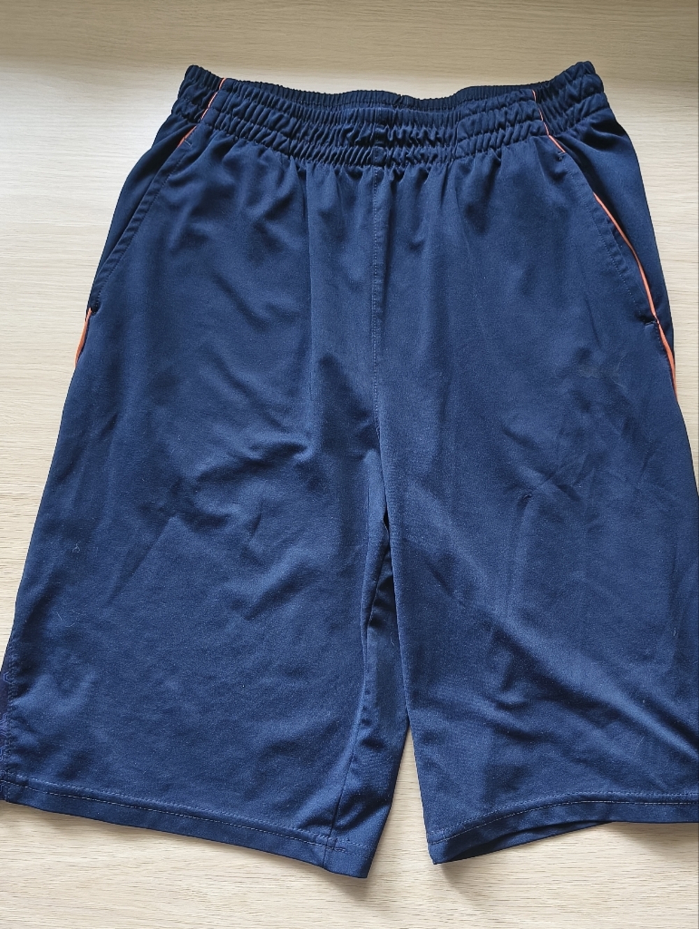 Puma Navy Blue Athletic Shorts with Orange Trim. Tech Design Print On Side